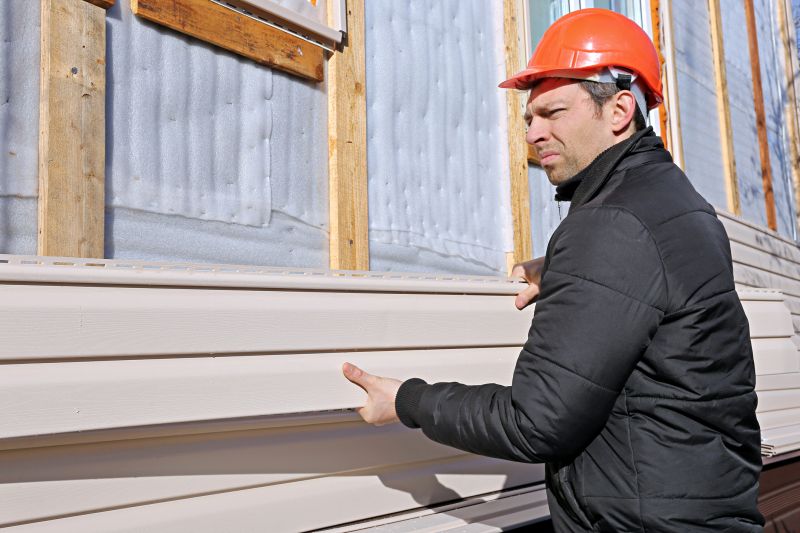 Professional Installer Adjusting Siding Panel